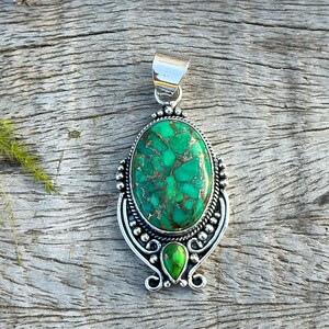 Artisan Green Copper Turquoise Pendant in solid 925 Sterling Silver. Oval turquoise stone accompanied by a second turquoise stone, showcasing a handmade elegance. Perfect anniversary present.