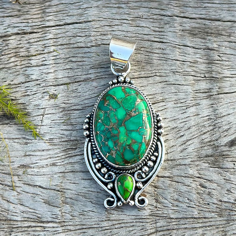 Artisan Green Copper Turquoise Pendant in solid 925 Sterling Silver. Oval turquoise stone accompanied by a second turquoise stone, showcasing a handmade elegance. Perfect anniversary present.
