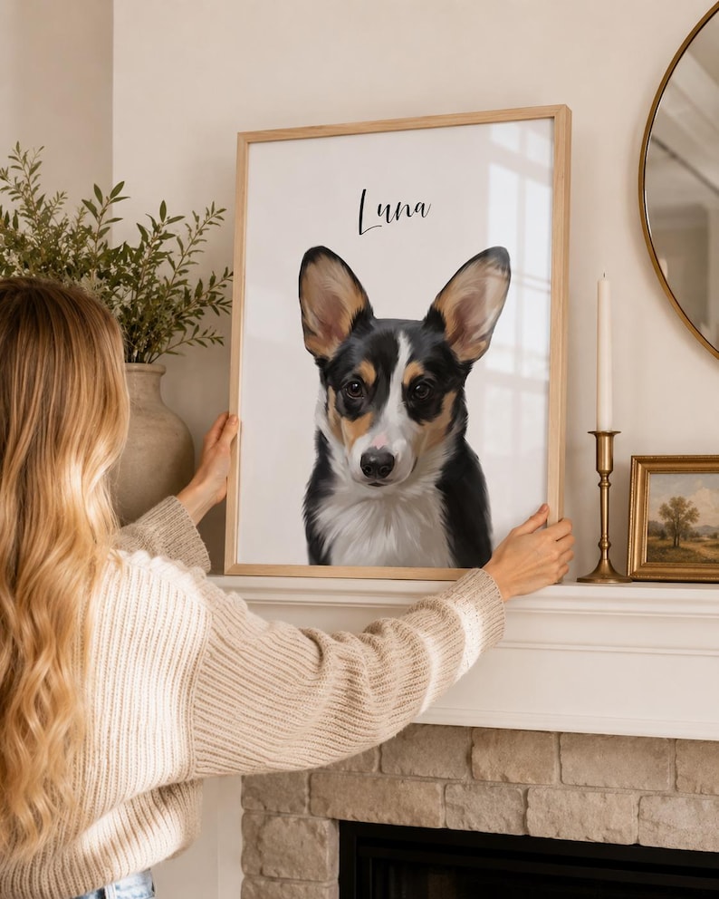May include: A framed portrait of a Corgi dog with black, white, and brown fur. The dog's name, "Luna," is written above the image in a cursive font. The frame is light-colored wood.