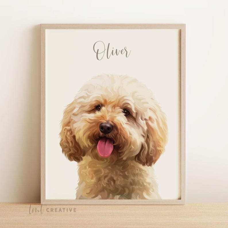 May include: A framed portrait of a fluffy, light brown dog with a pink tongue sticking out. The dog's name, "Oliver," is written in cursive above its head. The artwork is set against a cream-colored background.