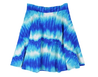May include: A flared skirt with a vibrant tie-dye pattern in shades of blue and white. The skirt has a comfortable waistband and a flowing silhouette, perfect for a casual or summer look. The fabric appears soft and lightweight.