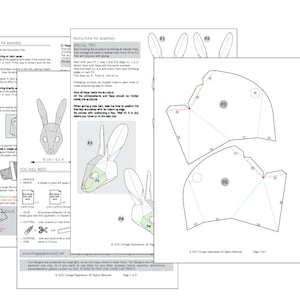 May include: Printed instructions for assembling a paper rabbit sculpture. The pages show diagrams, measurements, and assembly steps. The instructions include cutting, scoring, and folding details. The finished sculpture is approximately 16 cm.