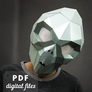 May include: A gray papercraft mask with geometric shapes and mesh eye coverings. The mask is worn by a person, but the person's face is not visible. The text "PDF digital files" is visible in the lower left corner of the image.