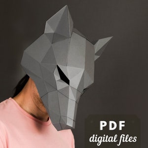 May include: A grey papercraft wolf mask with geometric shapes. The mask is being worn by a person with a pink shirt. The text "PDF digital files" is visible in the image.