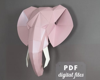 Może przedstawiać: Różowa papierowa rzeźba głowy słonia. Rzeźba wykonana jest ze złożonego papieru i ma efekt 3D. Kły słonia są białe.