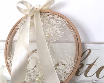 Cute ring bearer with French lace and wooden drum for a romantic wedding ring holder