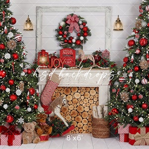 May include: A festive Christmas backdrop with two decorated trees adorned with red and white baubles, lights, and presents. A fireplace with a wreath, stocking, and rocking horse is in the centre. The text "Letters to Santa" is visible.