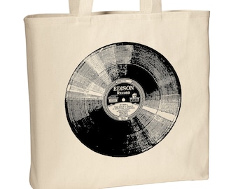 Op de afbeelding: Een beige canvas tote bag met een zwart-witte afbeelding van een Edison-plaat. Het platenlabel vermeldt "Edison Record" en "Side 1 - The Duck's Quack, A Backyard Jazzphony".