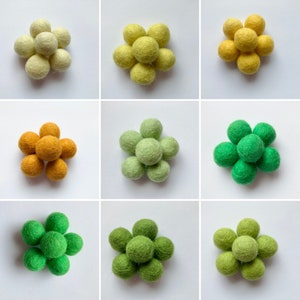 May include: A set of nine felt balls in three colors: yellow, green, and orange. The balls are arranged in a flower shape.