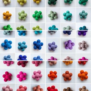 May include: Assortment of felt flower embellishments in various colors, including yellow, green, blue, purple, pink, orange, brown, and red. Each flower is made of six felt balls.