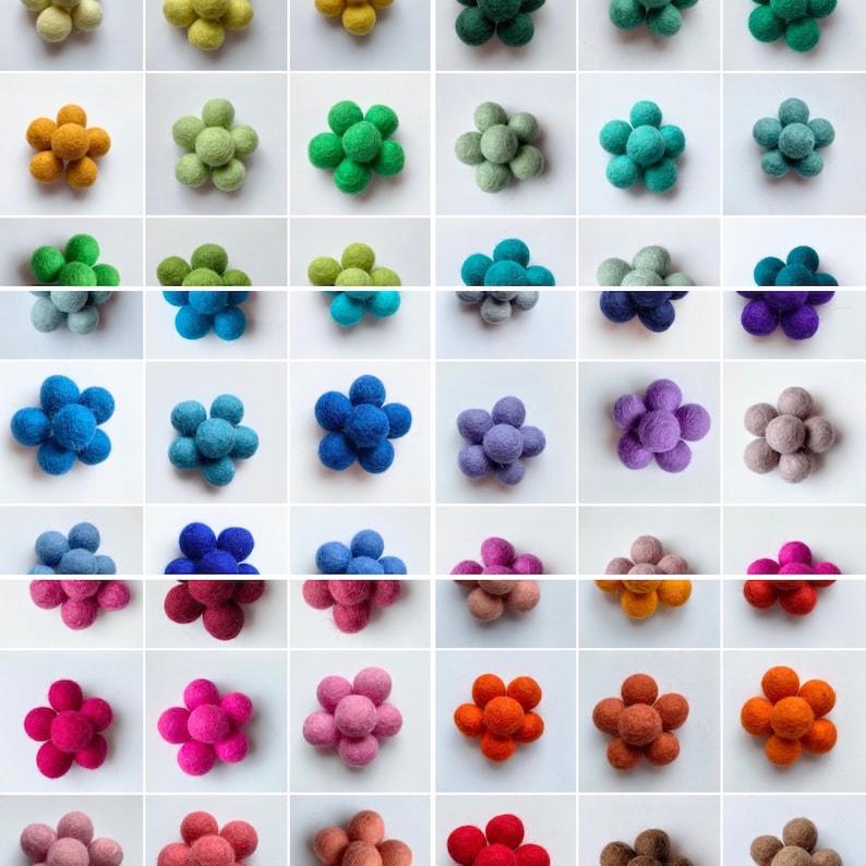 May include: Assortment of felt flower embellishments in various colors, including yellow, green, blue, purple, pink, orange, brown, and red. Each flower is made of six felt balls.