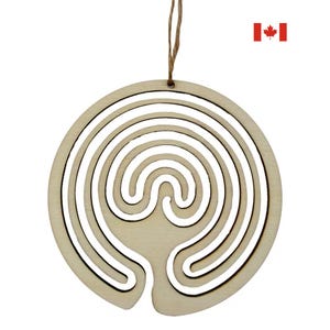 May include: A wooden labyrinth ornament with a natural finish, featuring a circular design with a maze-like pattern. It is suspended by a twine string. The ornament is approximately 10 cm in diameter.