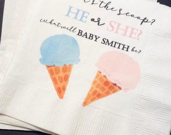 May include: White paper napkins with the text "What's the scoop? HE or SHE? what will BABY SMITH be?" and illustrations of ice cream cones. One ice cream cone has blue ice cream, and the other has pink ice cream.