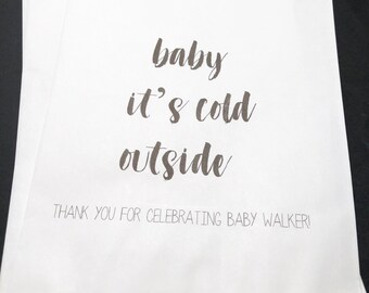 May include: White paper gift bags with the text "baby it's cold outside" and "Thank you for celebrating baby Walker!"