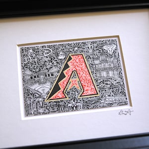 May include: A framed black and white doodle art print of the Arizona Diamondbacks logo. The logo is red and gold and is surrounded by a detailed doodle of a baseball field and other sports-related imagery. The print is signed "d.smith" in the bottom right corner.