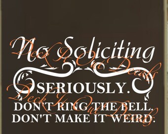 May include: A brown rectangular sign with the words "No Soliciting" in a decorative font. Below, it reads "SERIOUSLY. DON'T RING THE BELL. DON'T MAKE IT WEIRD." The sign is framed in a gold colour.