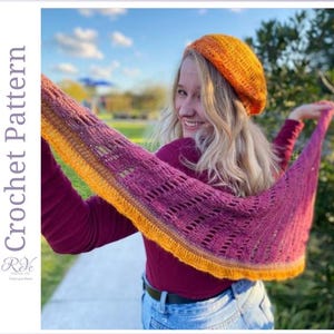 May include: A woman models a crocheted Sigmoid Scarf, a pattern available on Etsy. The scarf is a gradient of purple and orange, with a lacy design. She also wears an orange beret. The text on the image says "Sigmoid Scarf".