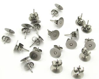May include: A set of 16 silver earring backs. The backs are round and have a small post that goes through the earlobe. The backs are made of metal and are designed to hold earrings in place.