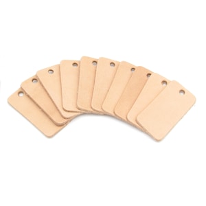 May include: Ten blank leather tags with holes for hanging. The tags are arranged in a semi-circle, with the largest tag at the bottom.