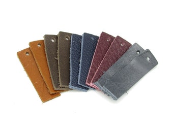 May include: A set of nine leather swatches in various colors, including brown, blue, gray, and burgundy. The swatches are arranged in a fan shape, with the darkest color at the bottom and the lightest color at the top.