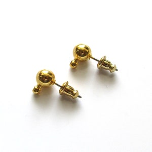 Two gold ball stud earrings with a post and optional gold plated barrel clutches.