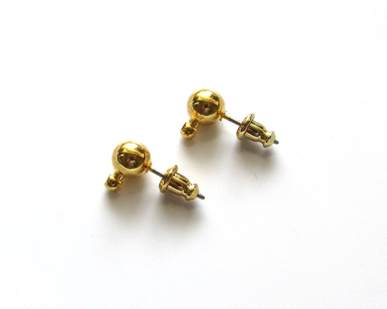 Two gold ball stud earrings with a post and optional gold plated barrel clutches.