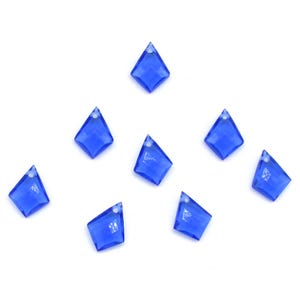 May include: Eight blue diamond-shaped crystal embellishments with a hole at the top for stringing.