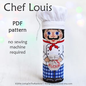 May include: PDF pattern for a cross-stitch doll of a chef named Louis. The doll is wearing a white chef's hat, a white chef's jacket with red accents, blue and white checkered pants, and holding a bag of flour. The text "Chef Louis" is at the top of the image, and the text "no sewing machine required" is below the doll.