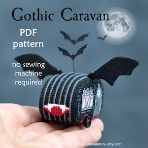 May include: A black and gray striped cross-stitch pattern of a gothic caravan with bats on top. The text "Gothic Caravan" is at the top of the image. The text "PDF pattern" is below the caravan. The text "no sewing machine required" is below the pattern text.