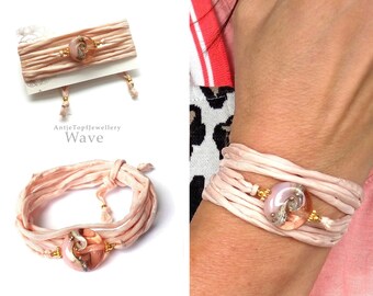 Wrap bracelet made of sand colored silk and handmade artist glass bead