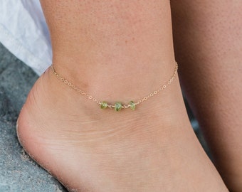 May include: A gold anklet with a delicate chain and three small green gemstone beads. 14K Gold Fill.