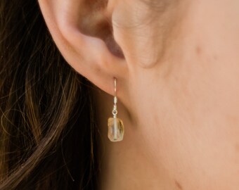 May include: Sterling silver earrings with a light brown, faceted gemstone dangle.
