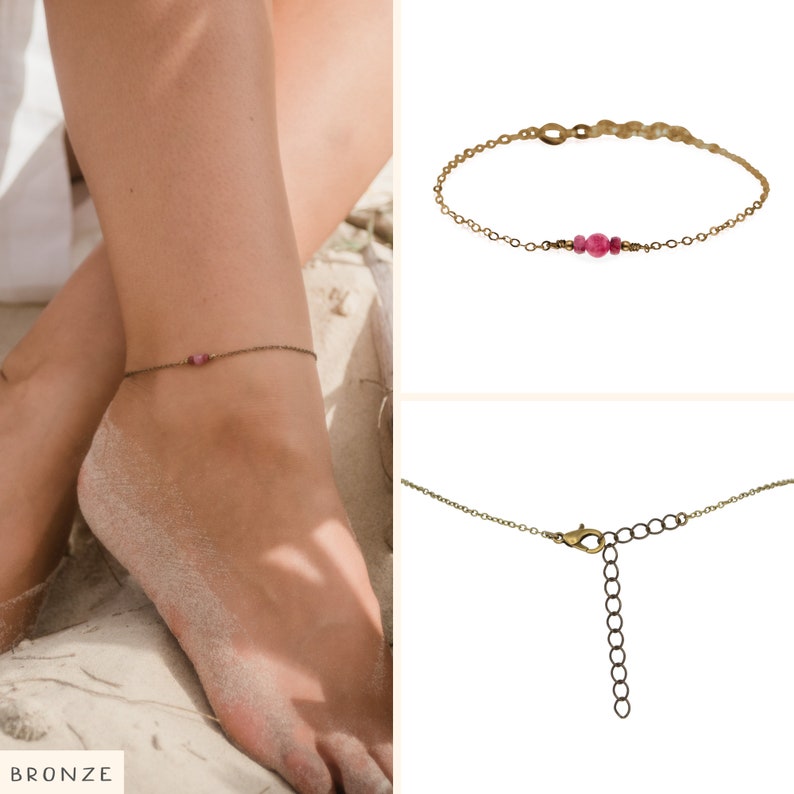 May include: A delicate gold anklet with a single pink gemstone. The anklet is shown on a model's ankle, with the word "BRONZE" visible in the bottom left corner of the image.