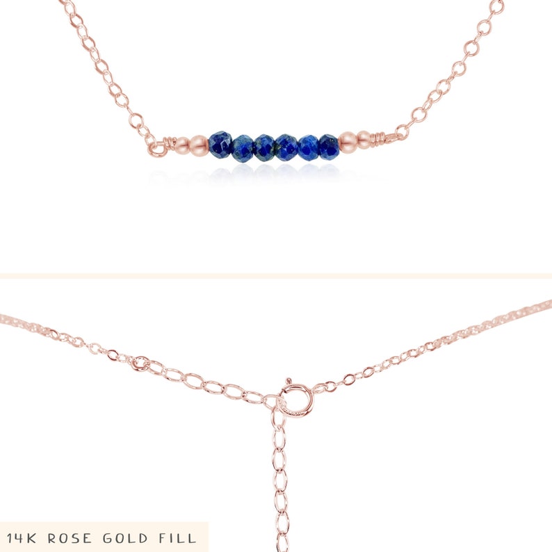 May include: A delicate gold chain necklace with a row of small, dark blue gemstone beads. The necklace is made of 14k rose gold fill.