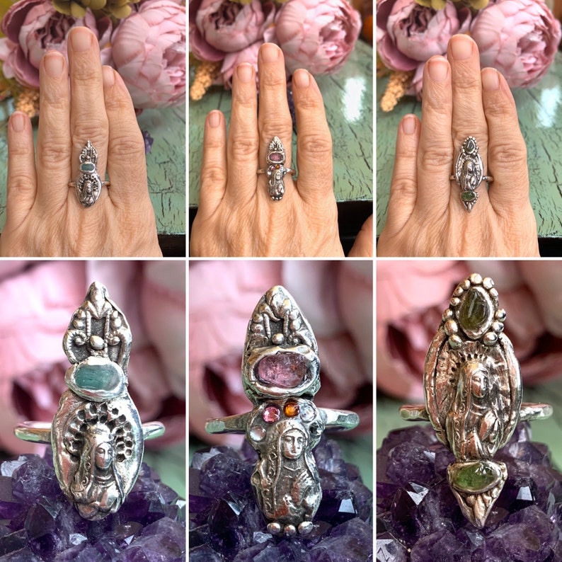 K&ouml;nnte beinhalten: Drei silberne Ringe mit einer religi&ouml;sen Figur in der Mitte, umgeben von bunten Edelsteinen. Die Ringe liegen auf einem violetten Hintergrund.
