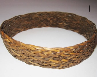 May include: A woven brown wicker ring, possibly a decorative piece or a traditional craft item.