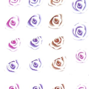 May include: A sheet of nail art stickers featuring 18 rose designs in three color variations: pink, purple, and brown. Each rose has a white outline and a swirl in the center.