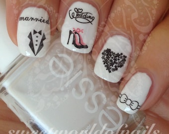 May include: White nail polish with black and white nail art decals. The decals include a tuxedo, a pair of high heels, a heart made of small flowers, a bow tie, and the words "married" and "wedding".