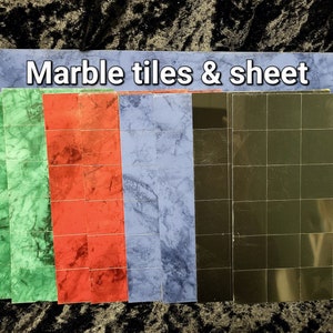May include: A set of marble tiles and a sheet in green, red, blue, and black. The tiles are arranged in rows and columns, and the sheet is a solid colour.