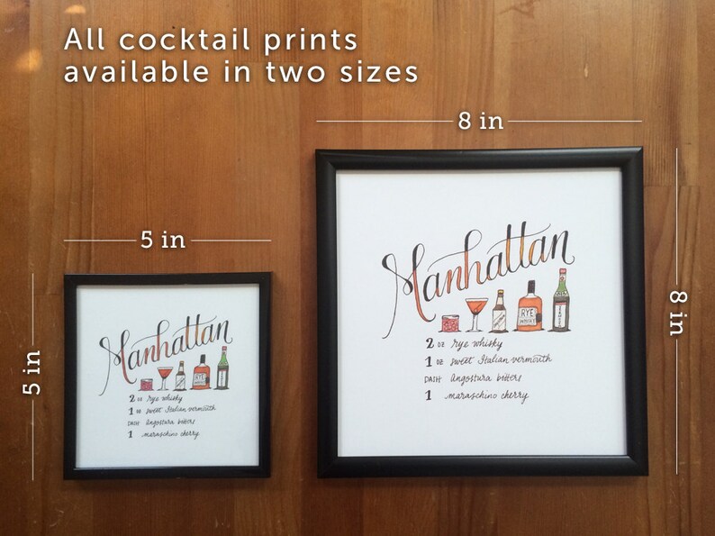 May include: Two framed Manhattan cocktail prints, 5 x 5 inches and 8 x 8 inches, with a handwritten recipe and illustrations of ingredients. The larger print is 8 inches (20 cm) square.