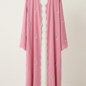 Pink front open Abaya with embroidered flowers and scalloped borders.