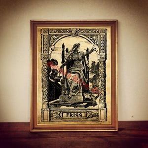 May include: A black and white illustration of the Norse goddess Frigg sitting on a throne. The image is framed in a gold frame and has a vintage aesthetic.