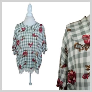 May include: A green and white gingham button-up shirt with a floral print and a lace trim. The shirt has a peter pan collar.