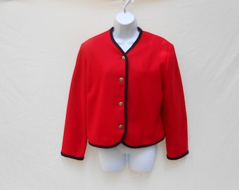 May include: A bright red jacket with a black trim and gold buttons. The jacket is displayed on a white mannequin. The jacket has long sleeves and a round neckline. The jacket is a classic style.