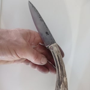 Folding knife with two deer antler nails