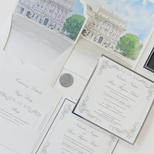 Puede incluir: Un conjunto de invitaciones de boda con un esquema de color plateado y blanco. La invitación presenta una ilustración de acuarela de un edificio con un borde decorativo. El texto de la invitación dice "Natasha Nayga y Ravi Shyam Patel" e incluye la fecha y la hora de la ceremonia y la recepción de la boda. La invitación también incluye la dirección del lugar.