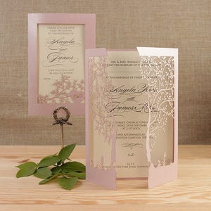 May include: A pink and white wedding invitation with a laser cut design of trees. The invitation reads "At the marriage of their children Angela and James".