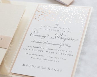 May include: A white wedding invitation with a peach border and gold foil confetti. The invitation reads "We request the pleasure of your company at an Evening Reception Saturday, the nineteenth of May Two thousand and twenty five Seven o'clock in the afternoon at Springbank, Townfield Lane, Chelsea, London SW4 Meghan and Henry"