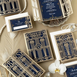 May include: Gold and navy blue wedding invitation suite with intricate laser cut designs. The invitation features the couple's names and wedding date. The RSVP card has a gold border and the text "RSVP by 04.07.2025". The order of service card has a gold border and the text "Order of Service".