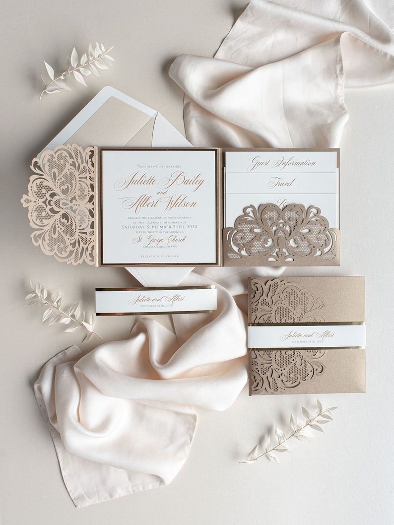 May include: A wedding invitation suite with a laser-cut design in a beige color. The invitation features the names "Juliette Bailey and Albert Wilson" and the date "September 24th, 2020". The invitation is accompanied by a RSVP card and a details card.